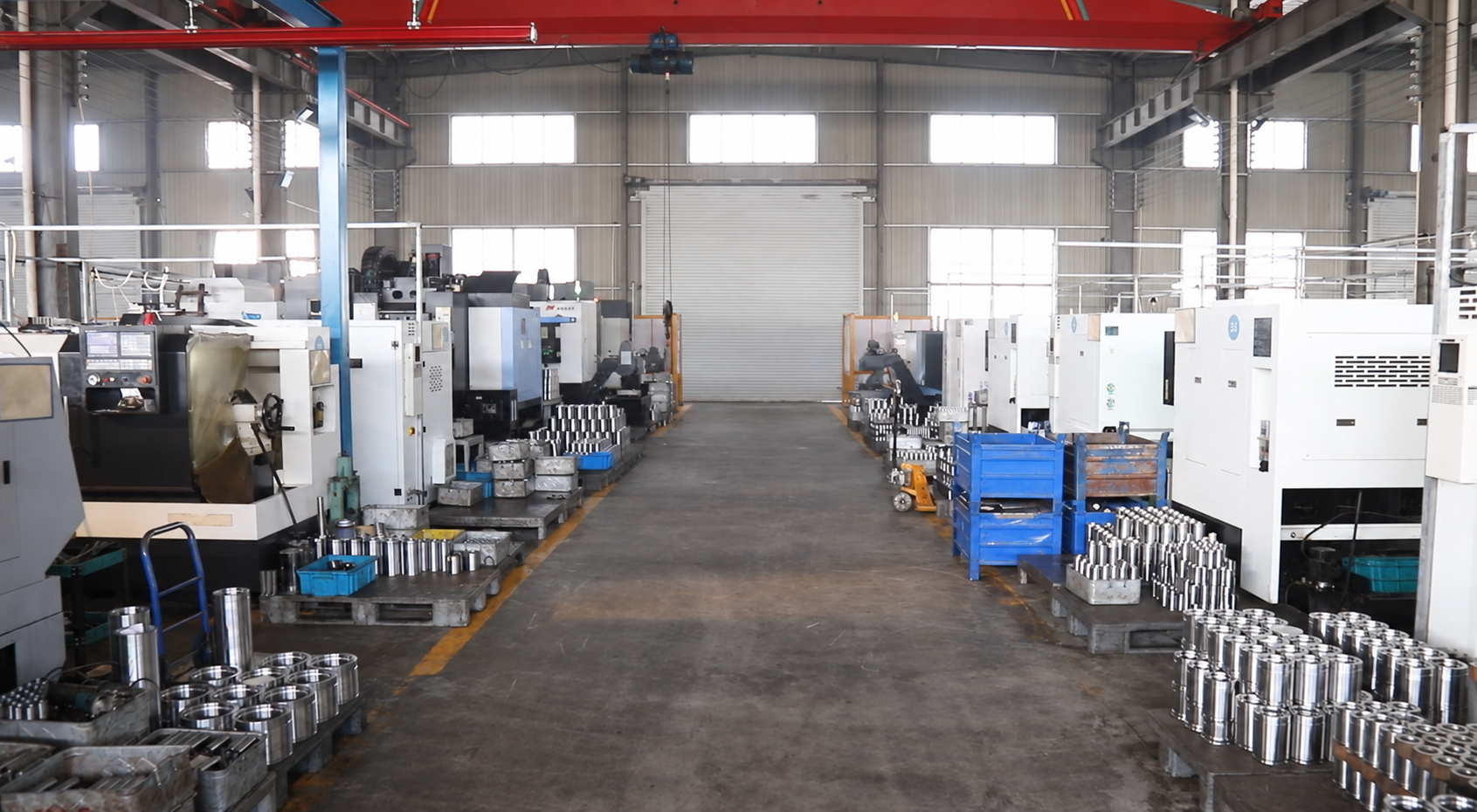 Representative wide workshop scene with a central production aisle and CNC equipment