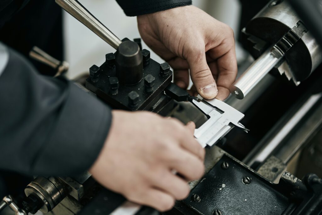 Calipers measuring a cylindrical metal component