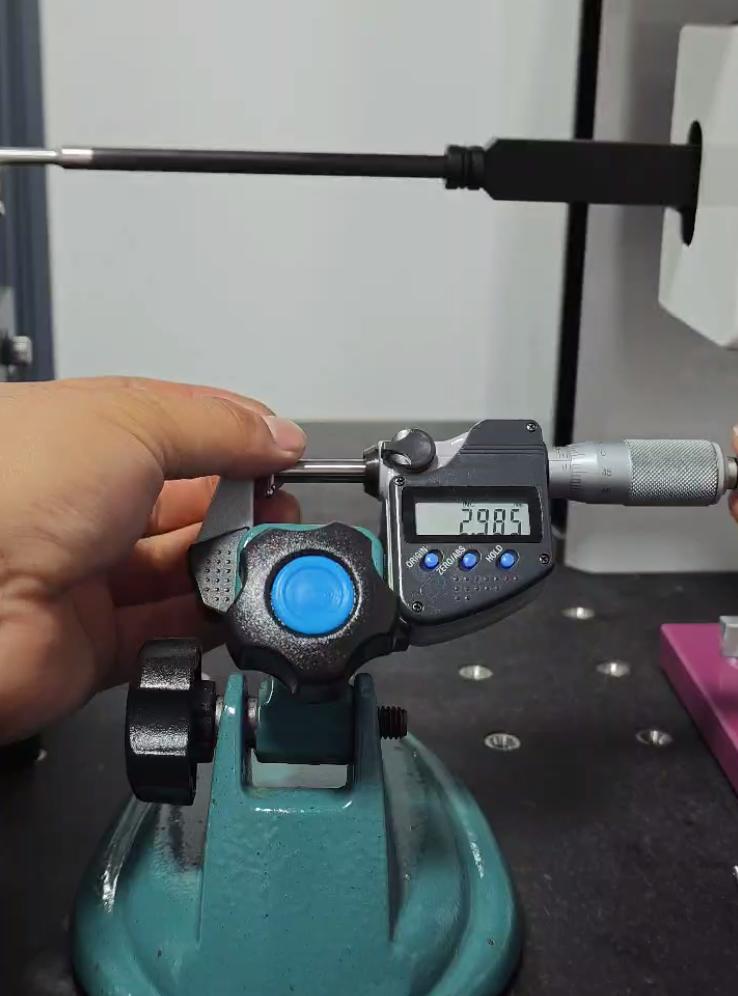 Digital micrometer measuring a metal component