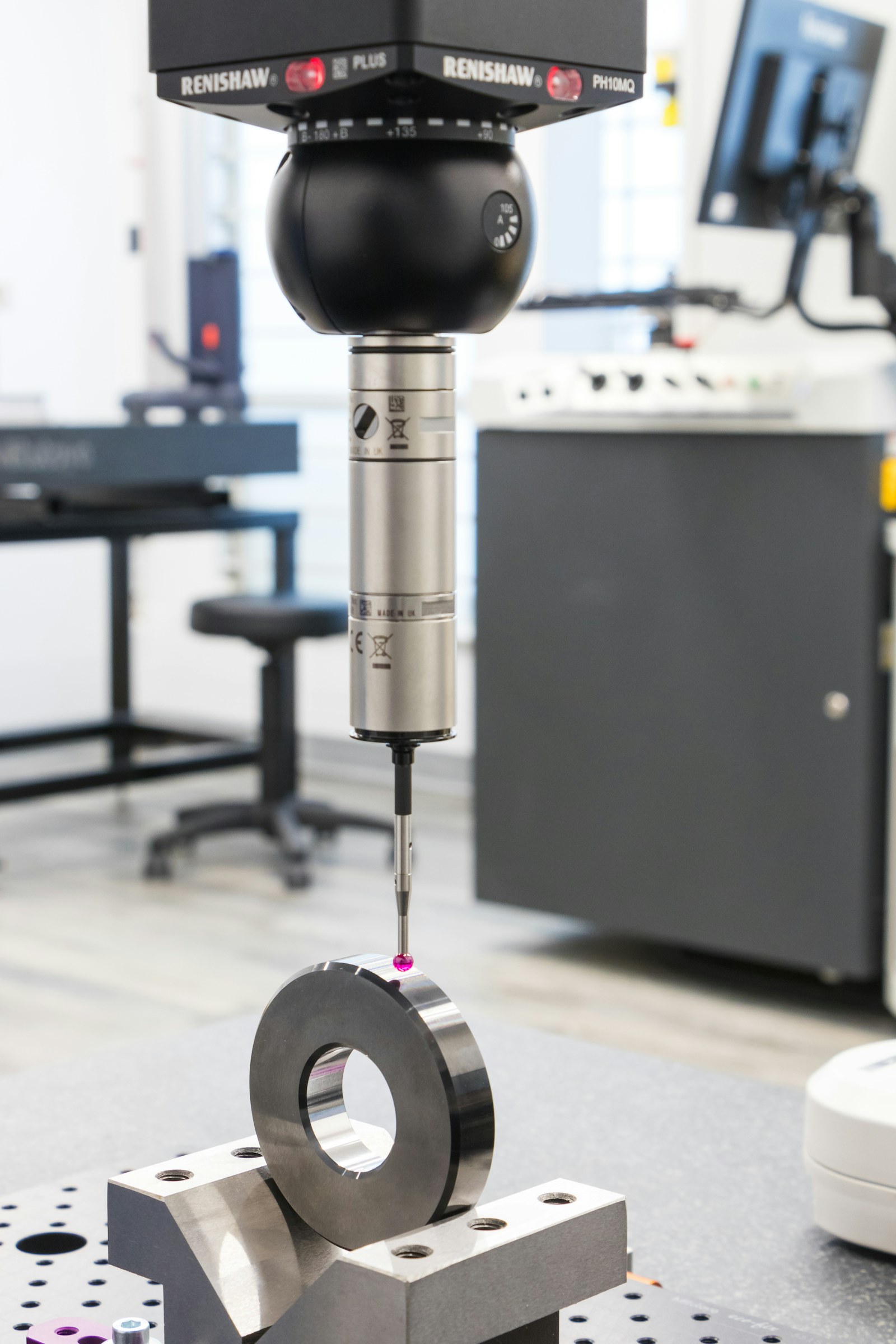 Contact measuring probe checking a machined metal ring