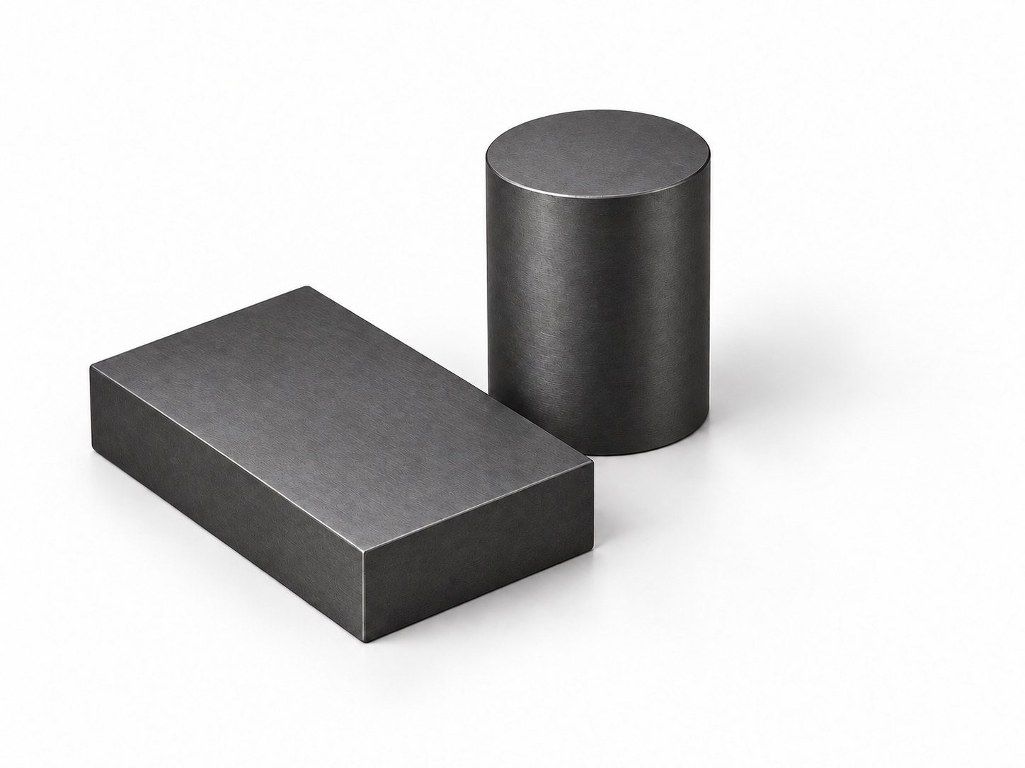 Illustrative dark graphite-gray rectangular and cylindrical carbide blanks; not proof of material grade
